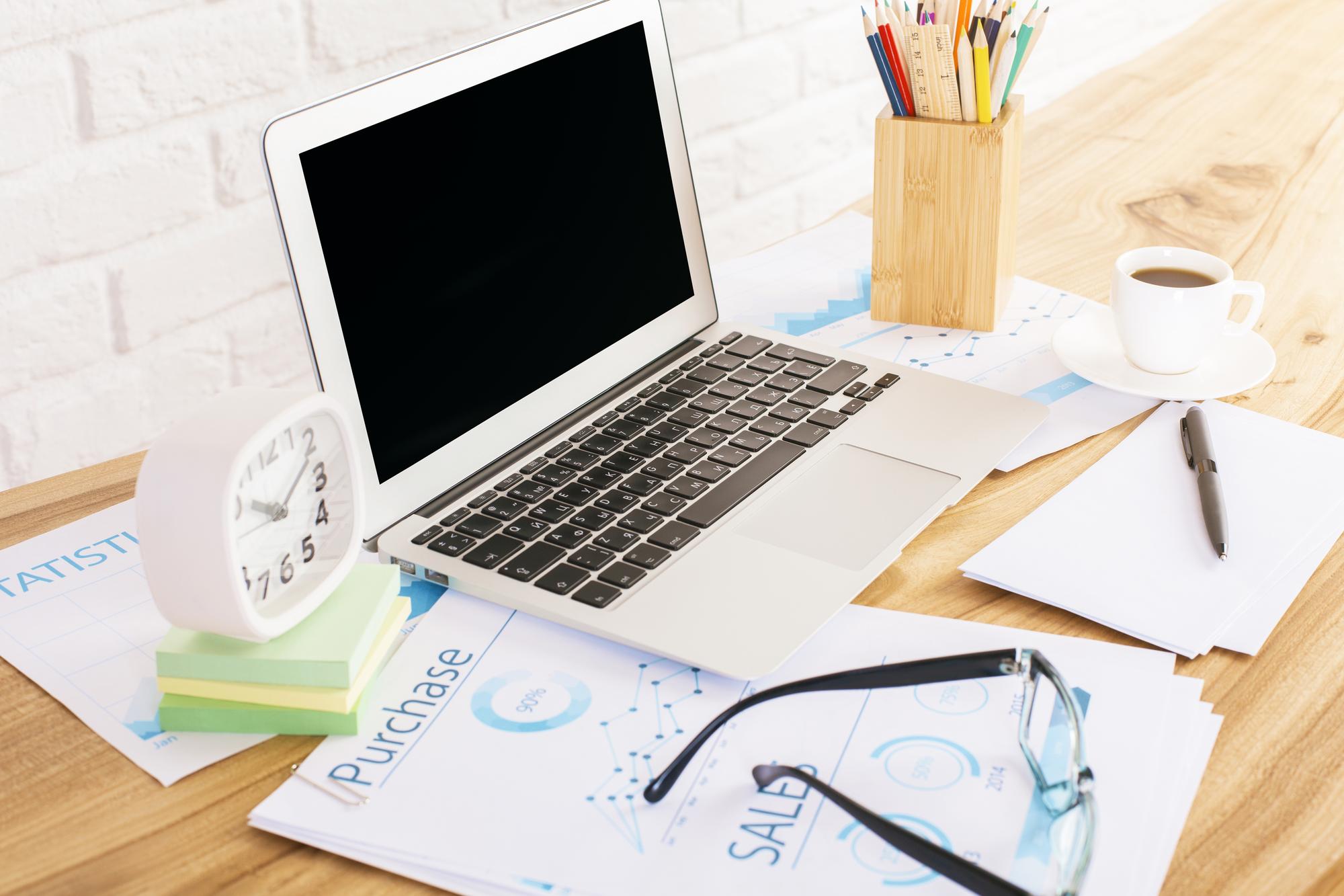 Workspace with finance notes and laptop